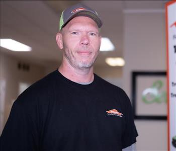 headshot of male crew chief in a black SERVPRO hat with a black SERVPRO shirt on