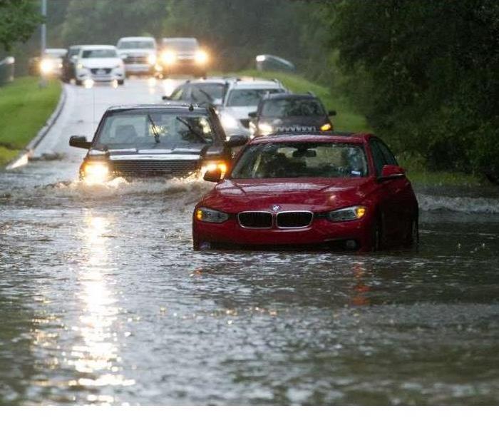 Cars on a flooded road.