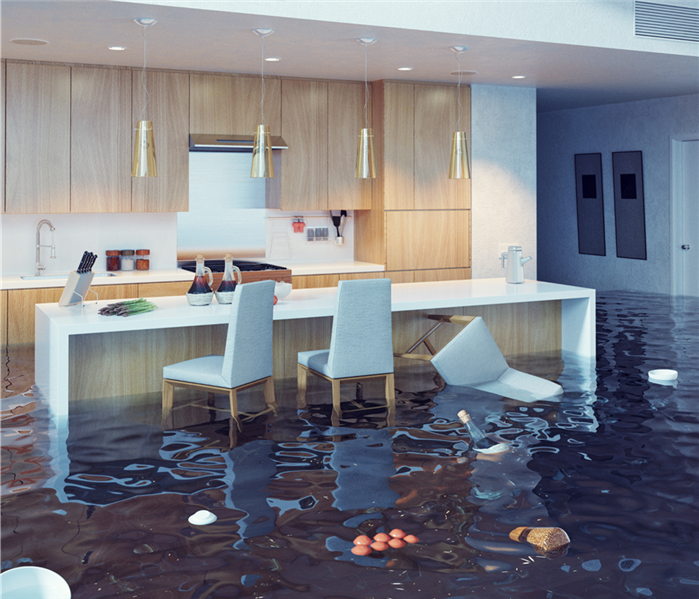 Kitchen flooded with brown water several things floating
